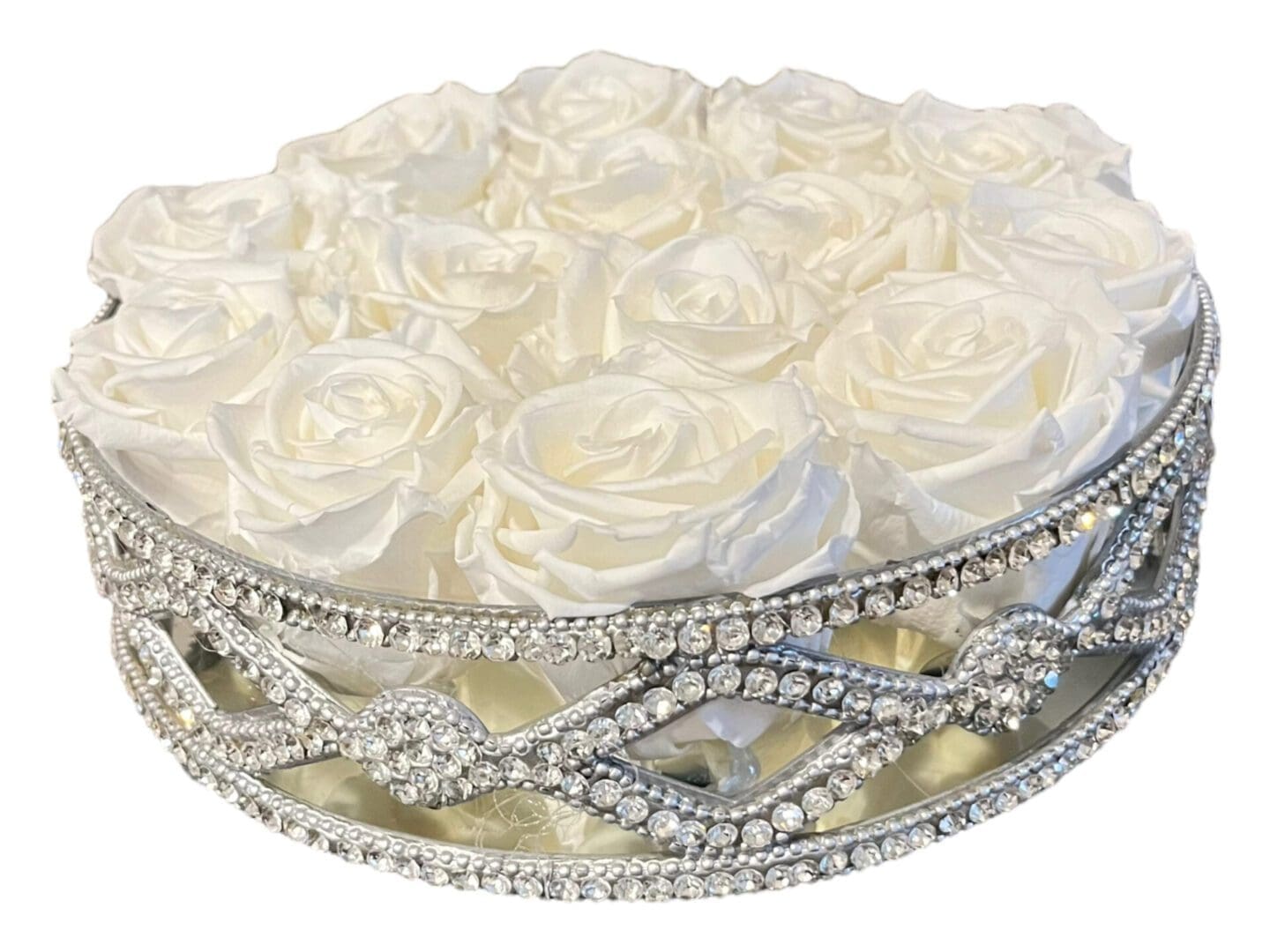 A round tray with white roses on top of it.