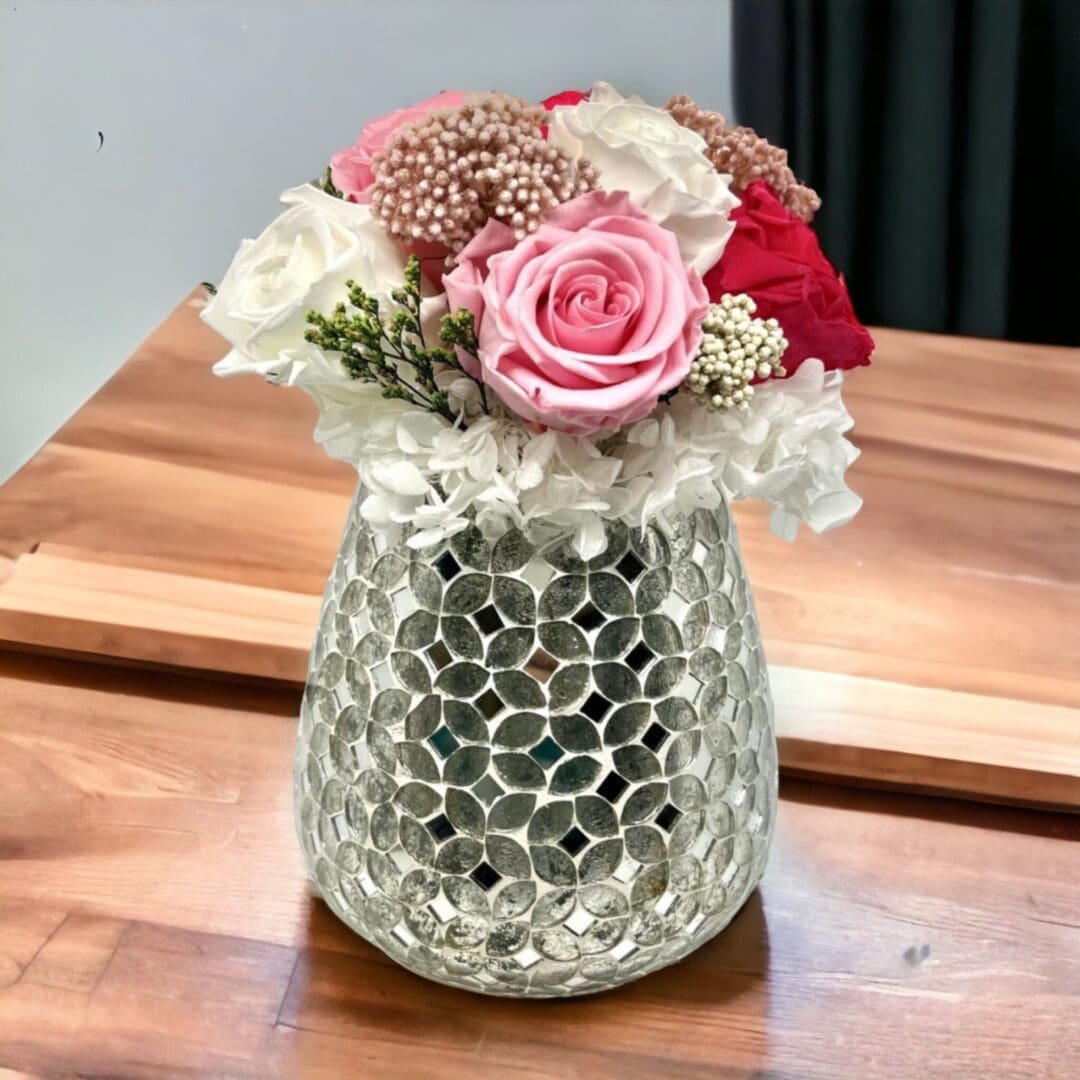 A vase with flowers in it on top of a table.