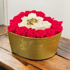 A gold box filled with red and white roses.