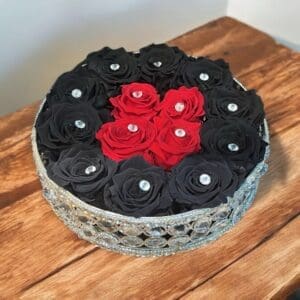 A cake with roses and diamonds on top of it.